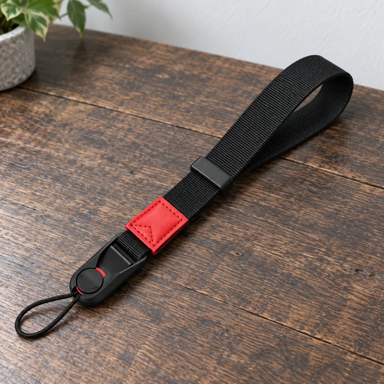 Asher Camera Wrist Strap in Red Accent; demonstration props not included