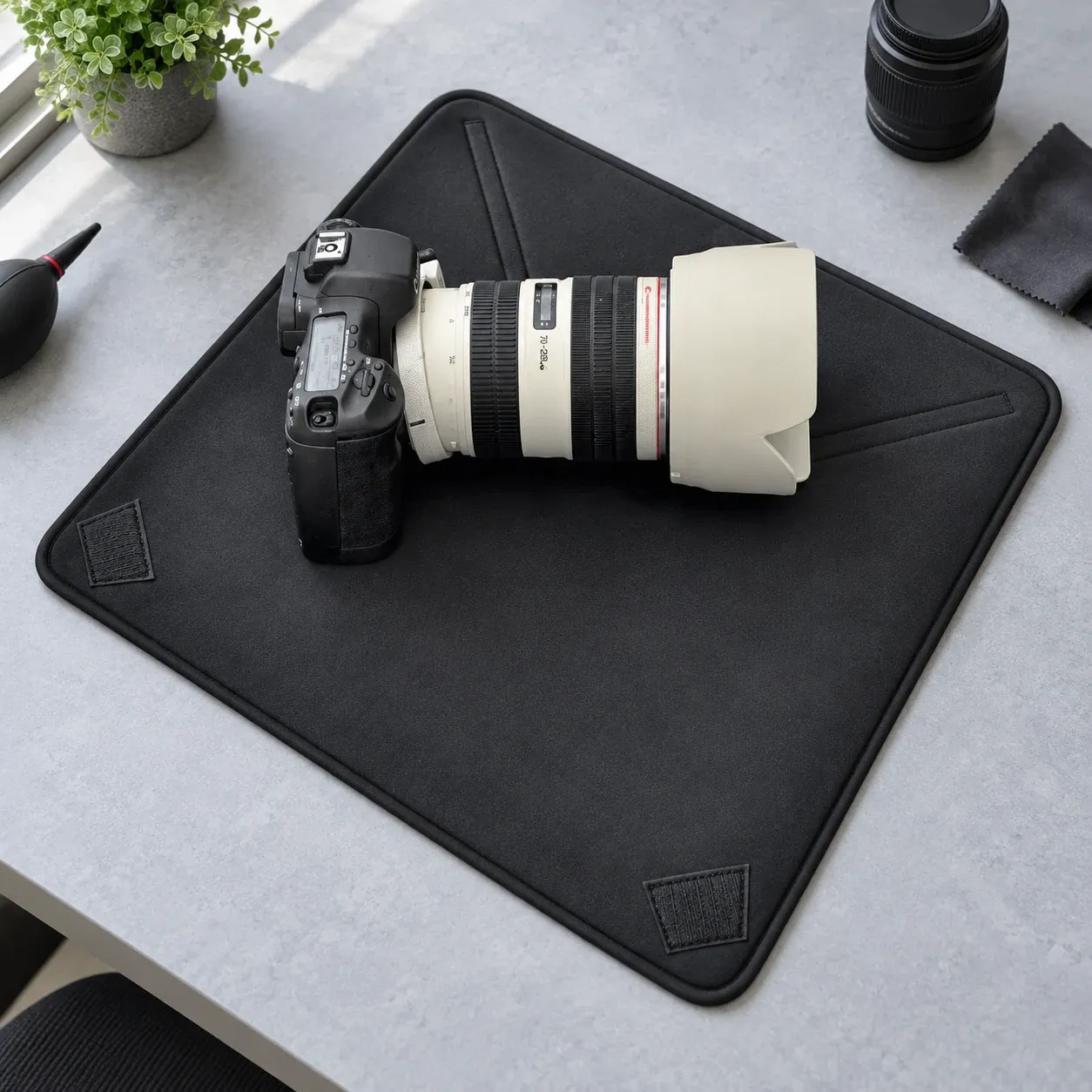 Open wrap beneath camera equipment; all camera gear is a demonstration prop and not included