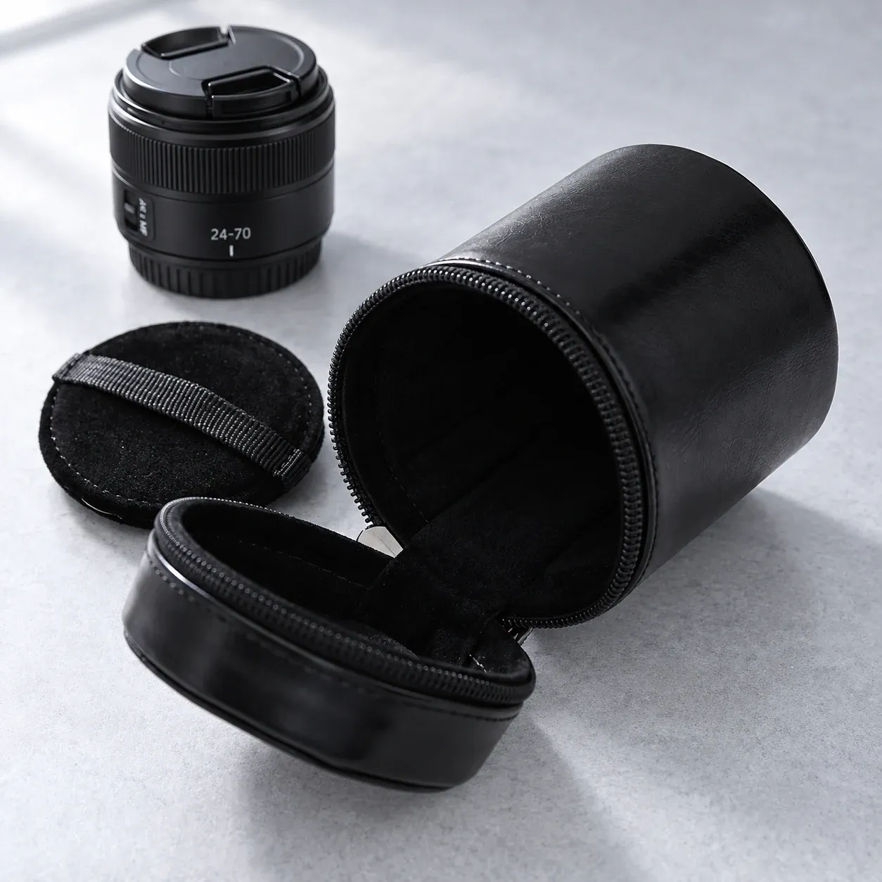 Open case with removable inner pad; illustrative lens is not included and does not establish compatibility